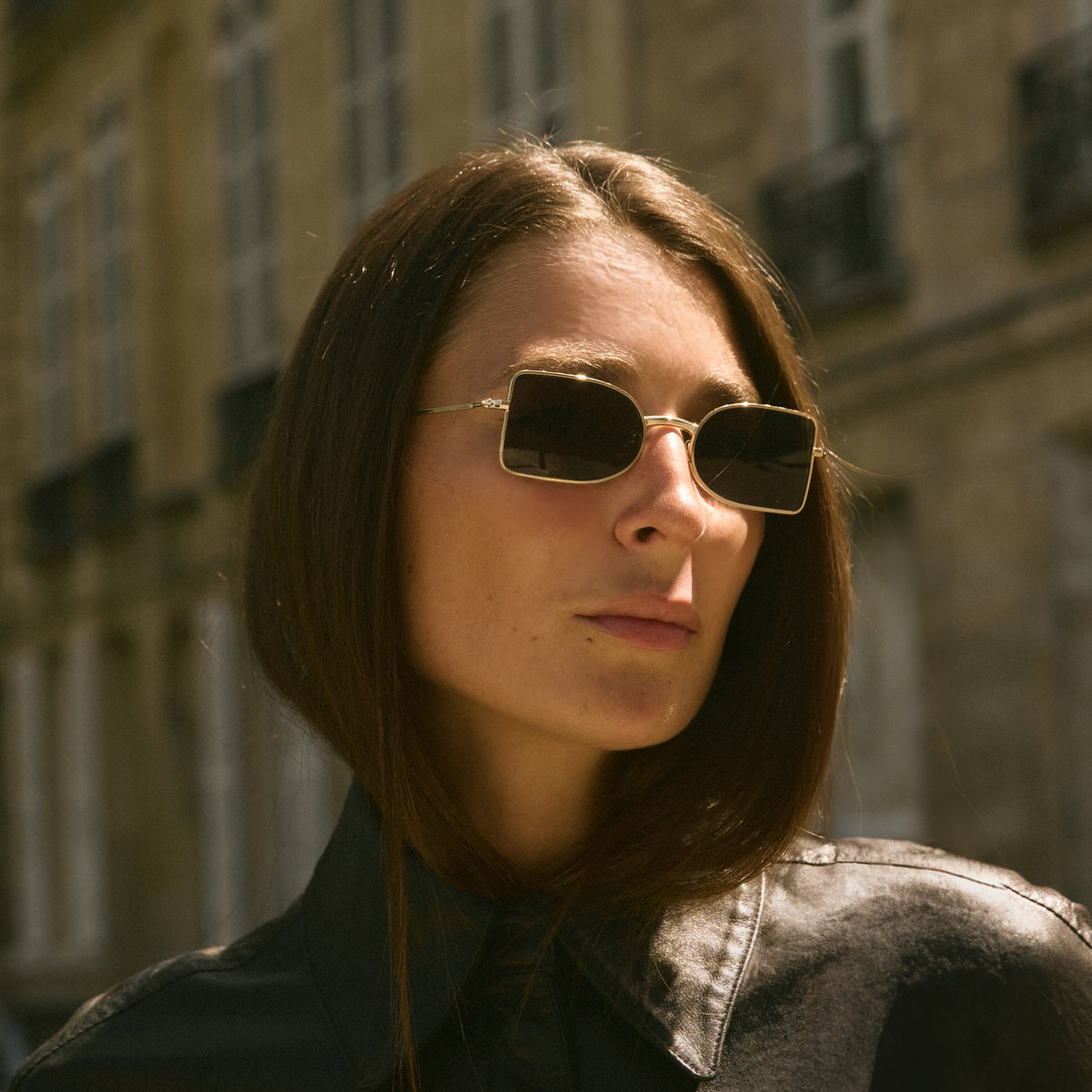 Woman wearing Nostrand Sunglasses in Gold with Grey lenses, Woman in Paris