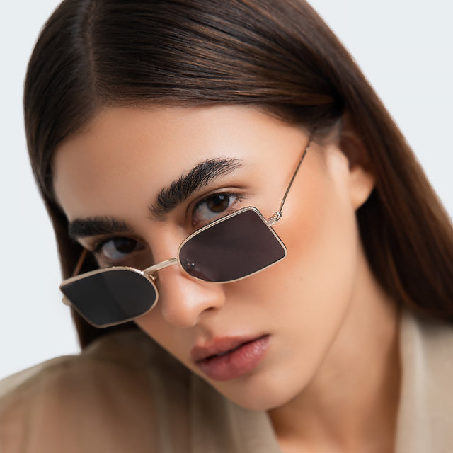Close up of woman in a beige blouse  wearing Nostrand Sunglasses Silver with Grey