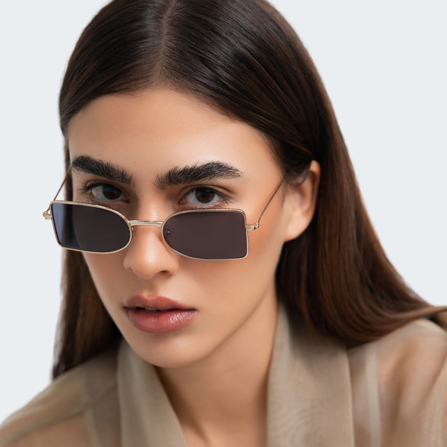 Woman in a beige blouse  wearing Nostrand Sunglasses Silver with Grey