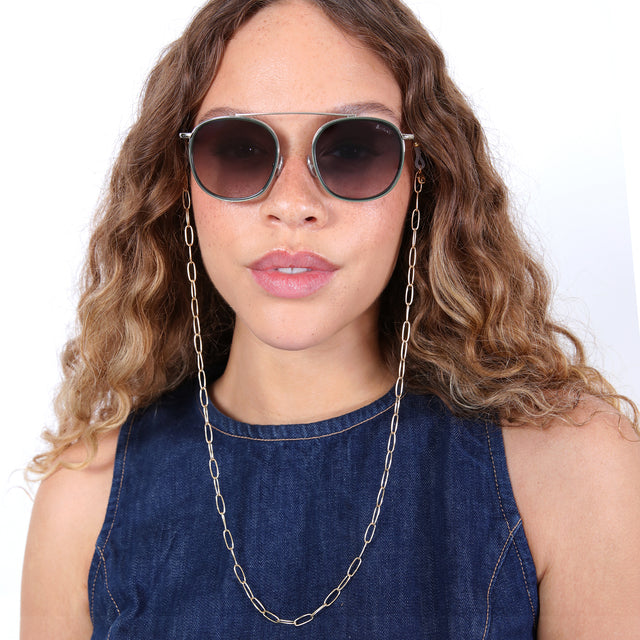 Brunette model with ombré, loose curls wearing Sunglass Chain Oval Link