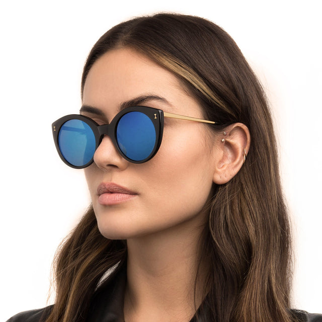 Model wearing Palm Beach Sunglasses in Black with Blue Mirror