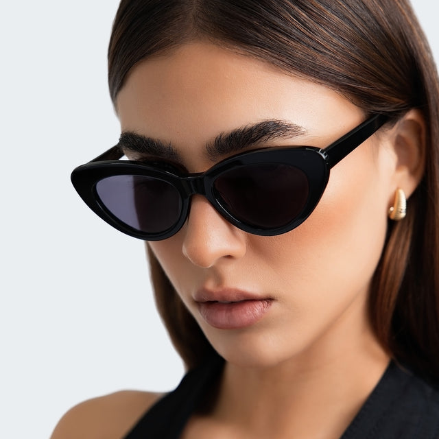 Woman in a black halter blouse wearing Pamela Sunglasses Black with Grey Flat
