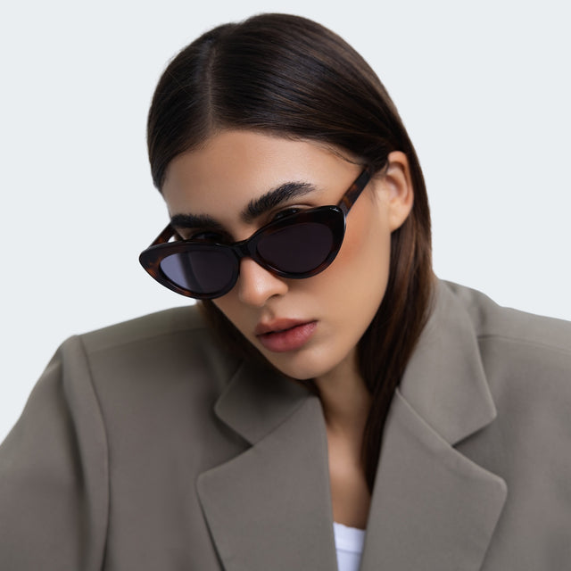 Another angle of a woman in a grey blazer wearing Pamela Sunglasses Havana with Grey Flat