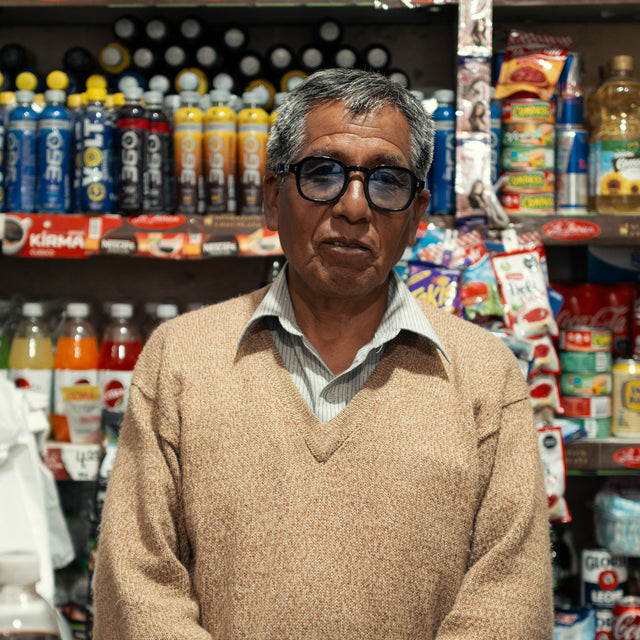 Peruvian man in a store wearing Washington Sunglasses in Black with Blue