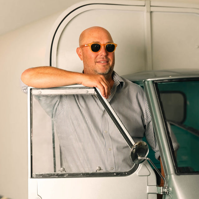 PopUp Bagels owner exiting a vintage car wearing PopUp Bagels x illesteva Sunglasses Matte Honey Gold with Olive