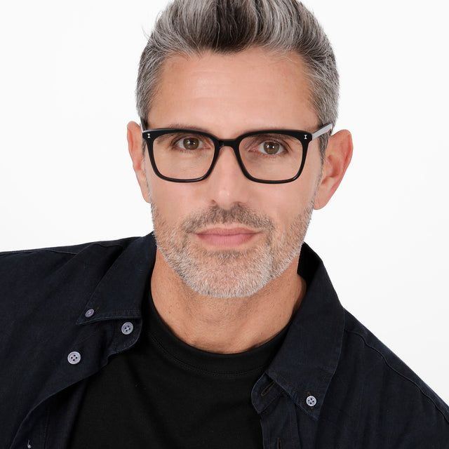 Model with salt and pepper hair and beard wearing Portland Optical Black Optical