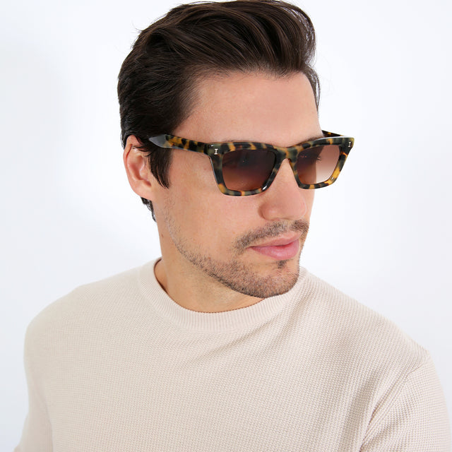 Model with short brown hair combed sideways Brunette model with ombré hair wearing Portugal Sunglasses Tortoise with Brown Flat Gradient