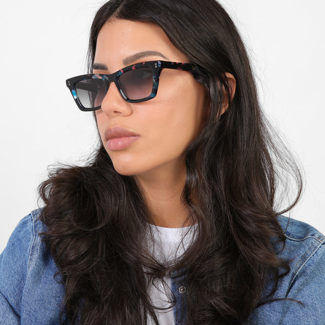 Brunette model looking right wearing Portugal Sunglasses Eclipse with Grey Flat Gradient