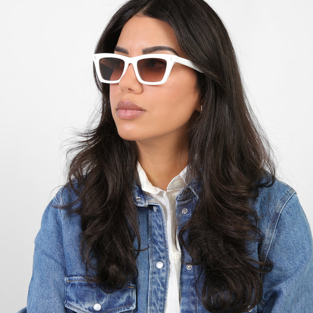 Brunette model looking right wearing Portugal Sunglasses White with Brown Flat Gradient