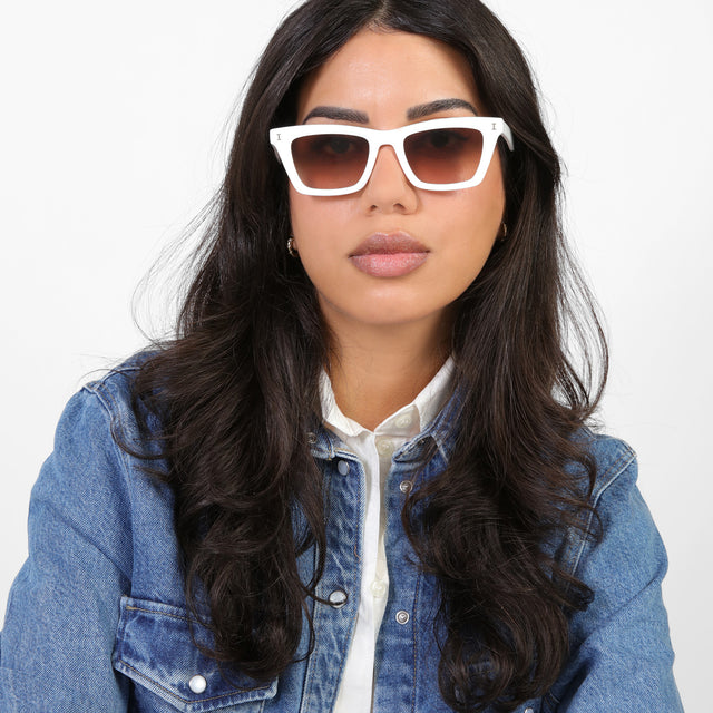 Brunette model in a denim jacket wearing Portugal Sunglasses White with Brown Flat Gradient