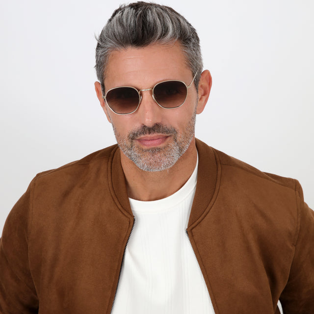 Model with salt and pepper hair and beard wearing Prince Sunglasses Rose Gold with Brown Flat Gradient