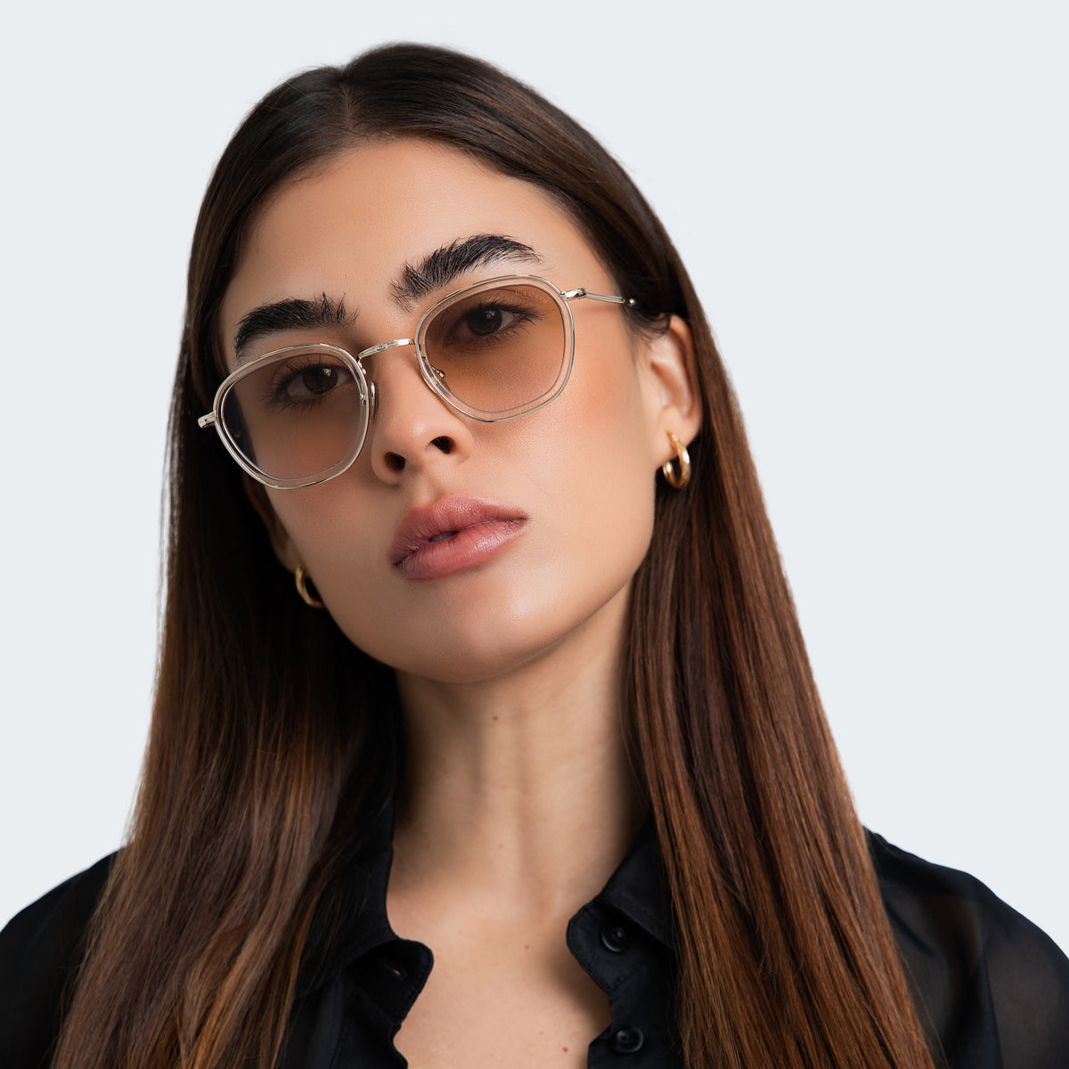 Woman wearing Prince Tate Sunglasses in Champagne with Gold lenses, front view, Woman in a black blouse