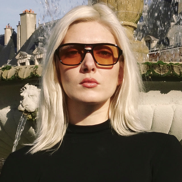 Woman in Paris wearing Queens Sunglasses Black with Sunset Flat