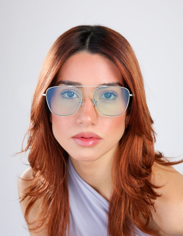 Woman in a periwinkle blouse wearing Samos Sunglasses in Silver with Mint See Through