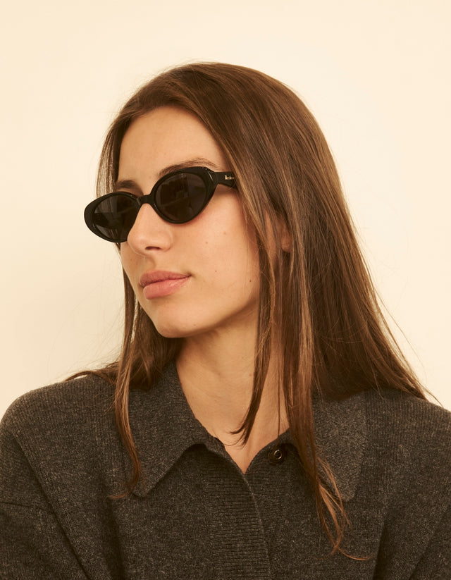 Woman wearing Sheila Sunglasses with a neutral background