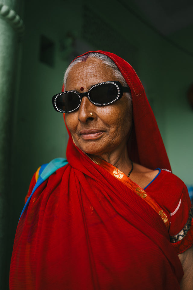 Woman in a red saree wearing the Shirley Crystal Sunglasses in Black