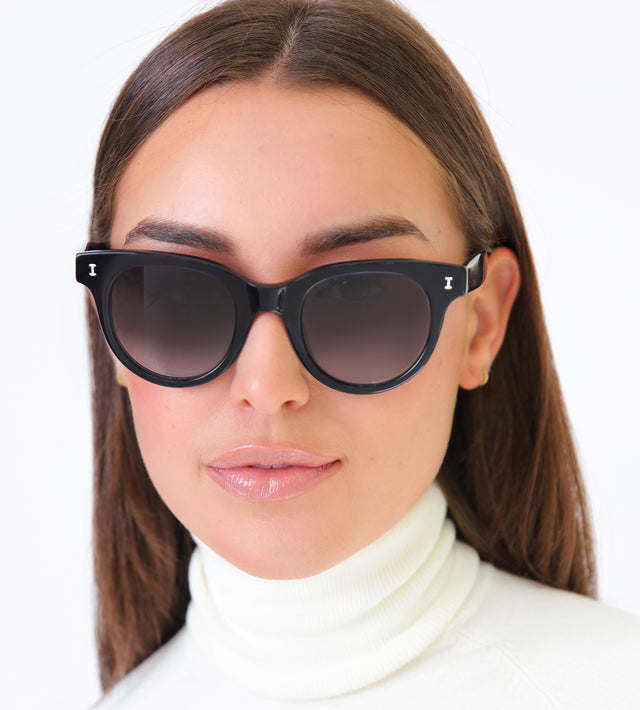 Brunette model wearing Sicilia Sunglasses Navy with Grey Gradient