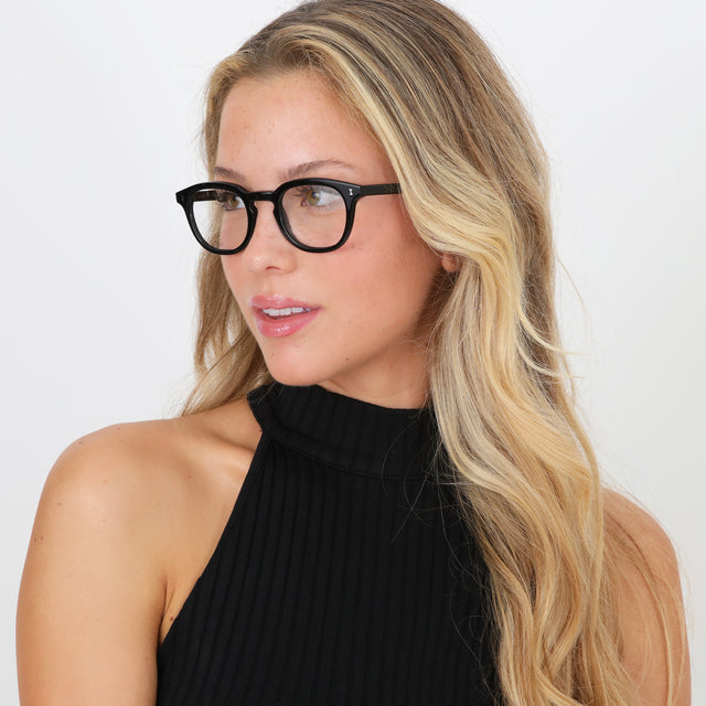 Blonde model with wavy hair wearing Slope Optical Black Optical