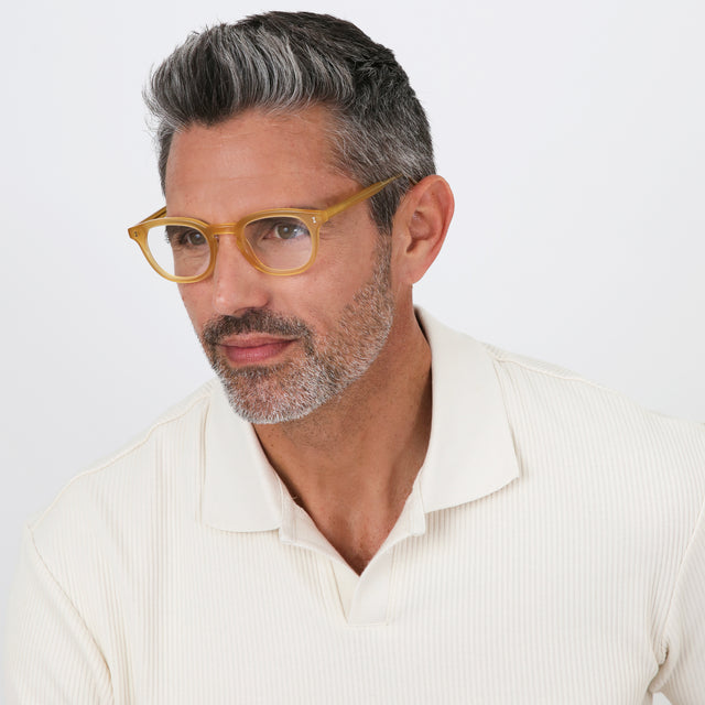 Model with salt and pepper hair and beard wearing Slope Optical Blond Optical