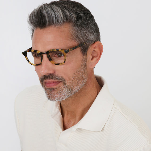 Model with salt and pepper hair and beard wearing Slope Optical Tortoise Optical