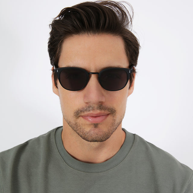 wearing Stockholm Sunglasses Matte Black with Grey