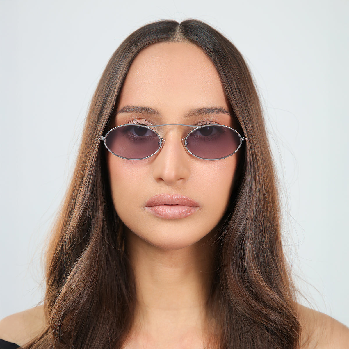 Woman wearing Sydney Sunglasses in Gunmetal with Grey Gradient lenses, front view, Another angle of woman with brown hair in an off-the-shoulder blouse