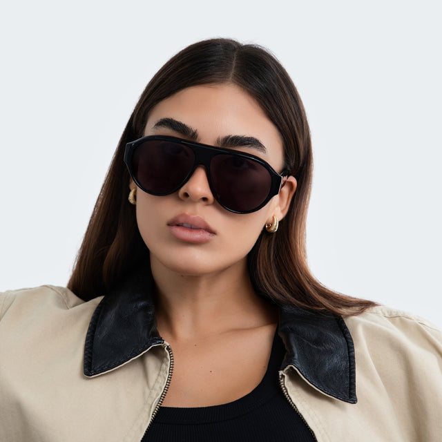 Woman in a trench coat wearing Telluride Sunglasses Black with Grey