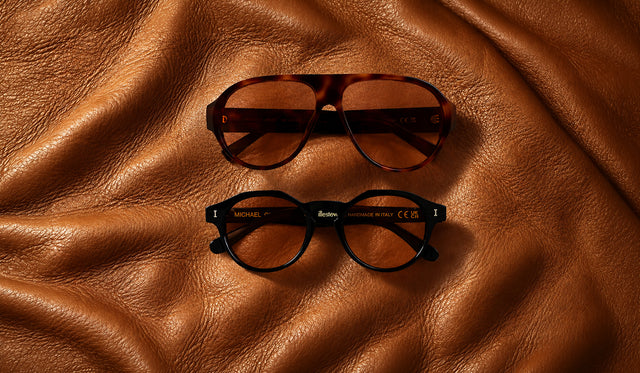 Telluride and Michael Sunglasses in new Desert see through lens options over a brown leather couch cushion
