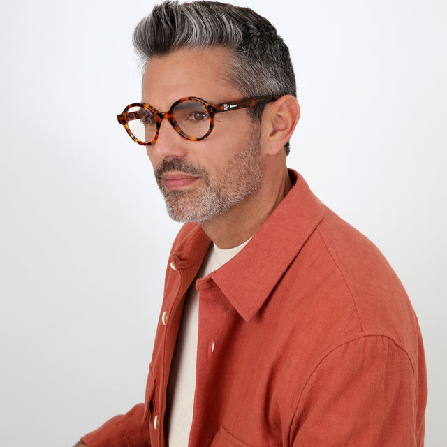 Model with salt and pepper hair and beard wearing The Met x illesteva Optical Light Tortoise Optical