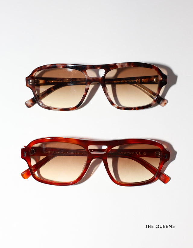 Two pairs of Queens sunglasses with taupe gradient lenses, displayed vertically on a white background