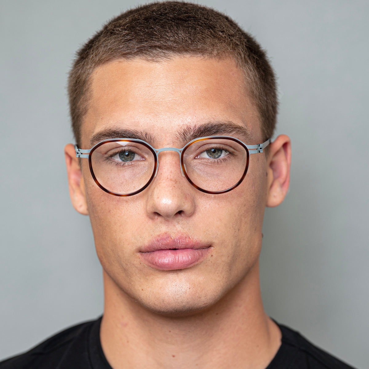 Man wearing Tompkins Titanium Optical in Havana with Matte Gunmetal Optical lenses, Model with buzzcut hairstyle