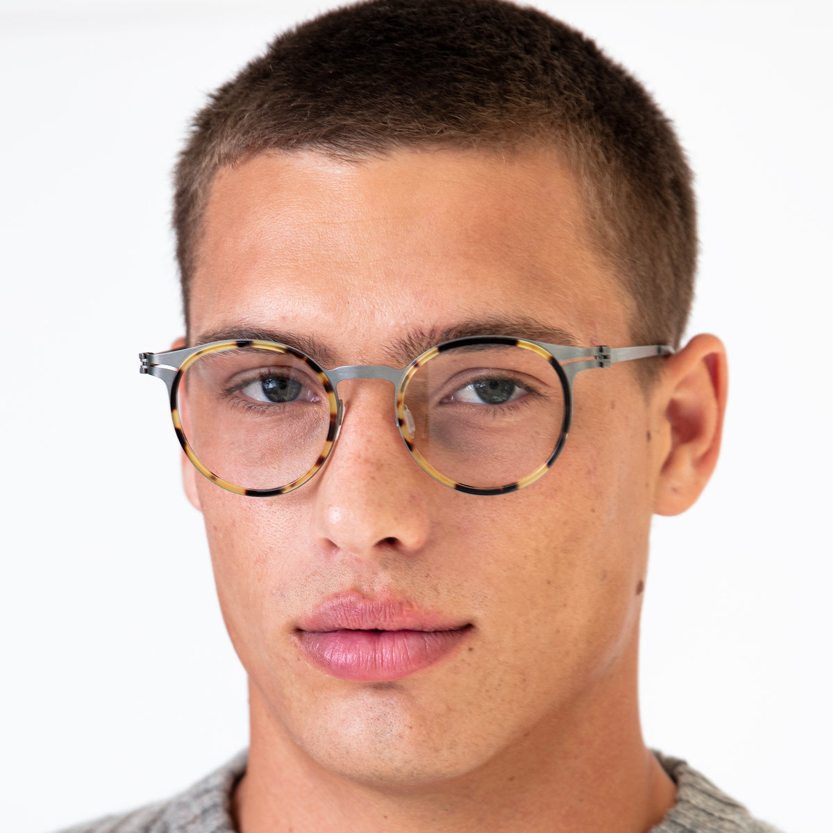 Man wearing Tompkins Titanium Optical in Tortoise with Matte Silver Optical lenses, Model with buzzcut hairstyle
