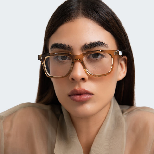 Woman in a beige blouse wearing Toscana Optical Brown Optical