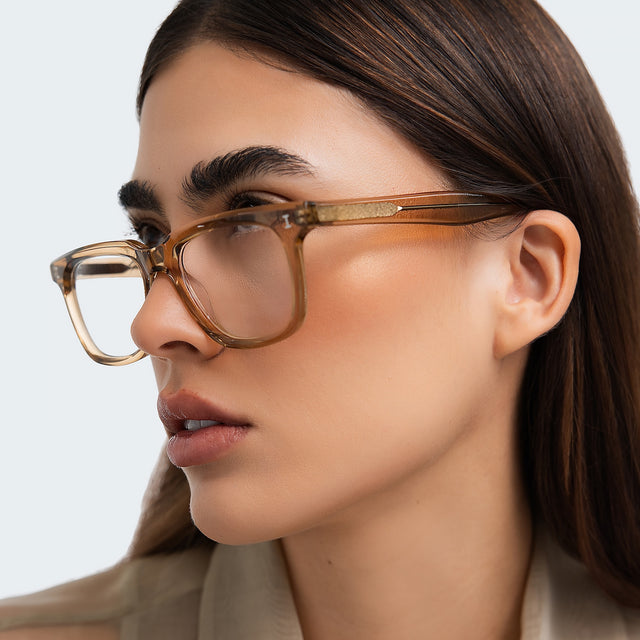 Close up of woman in a beige blouse wearing Toscana Optical Brown Optical