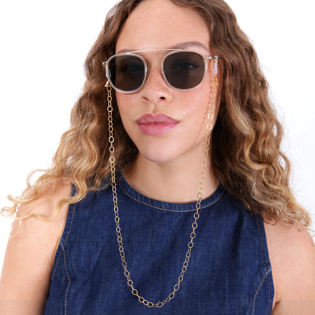 Brunette model with ombré, loose curls wearing Sunglass Chain Trace