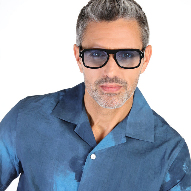 Model with salt and pepper hair and beard wearing Trancoso Sunglasses Black with Blue Gradient See Through