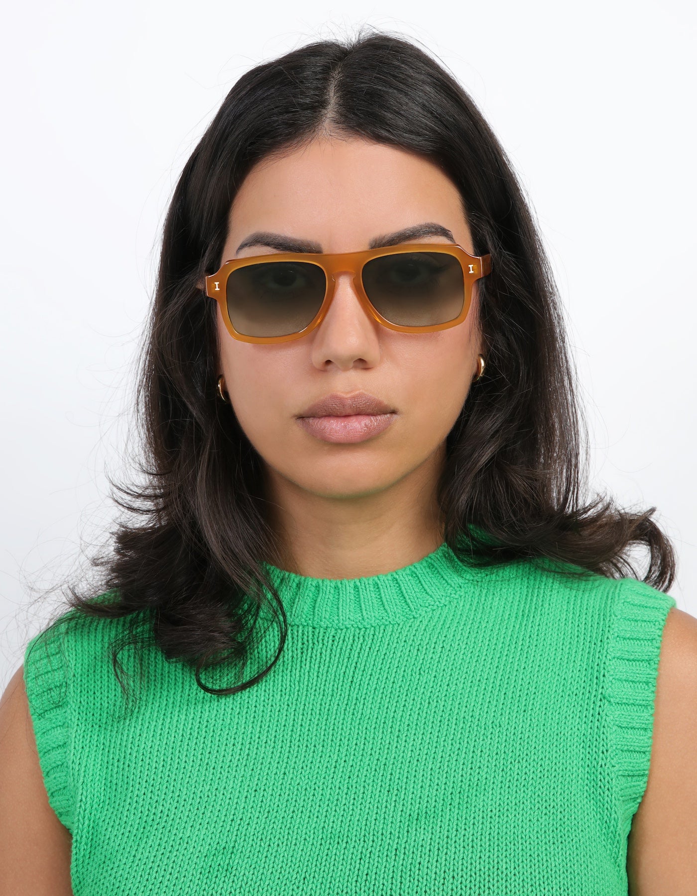 Brunette model wearing Trancoso Sunglasses in Honey with Olive Gradient