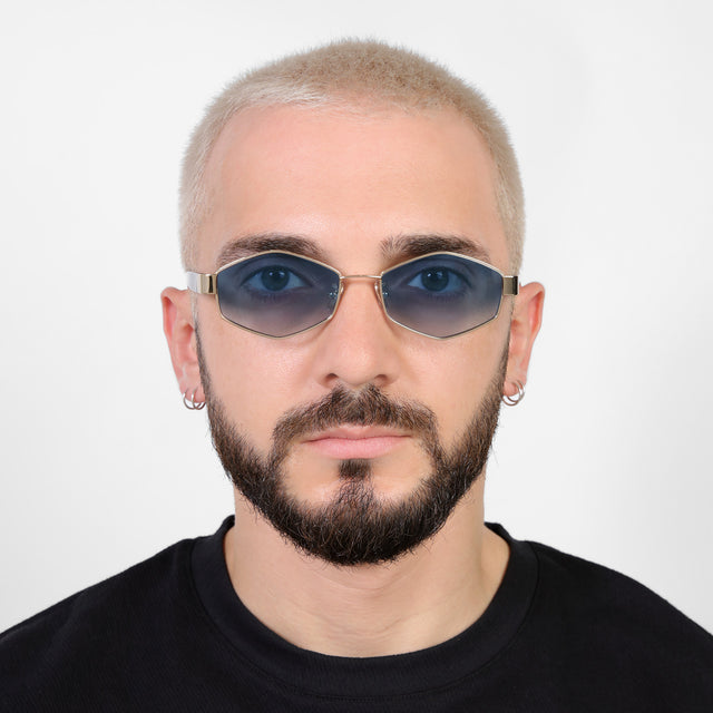 Model with a platinum buzzcut wearing Tucson Sunglasses Gold/Star Tortoise with Midnight Blue Gradient