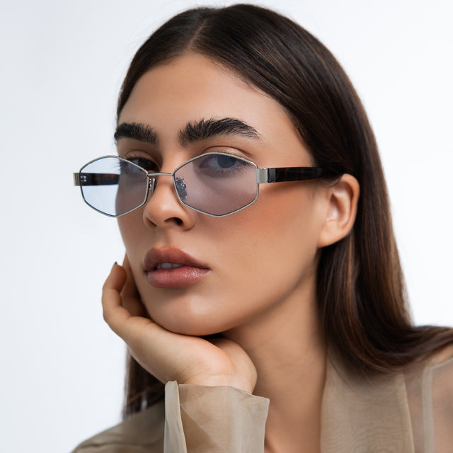 Woman in a trench coat wearing Tucson Sunglasses Silver/Havana with Light Blue See Through