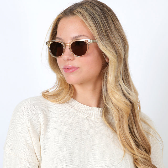 Blonde model turned to her right wearing Veneto Sunglasses Champagne with Brown Flat