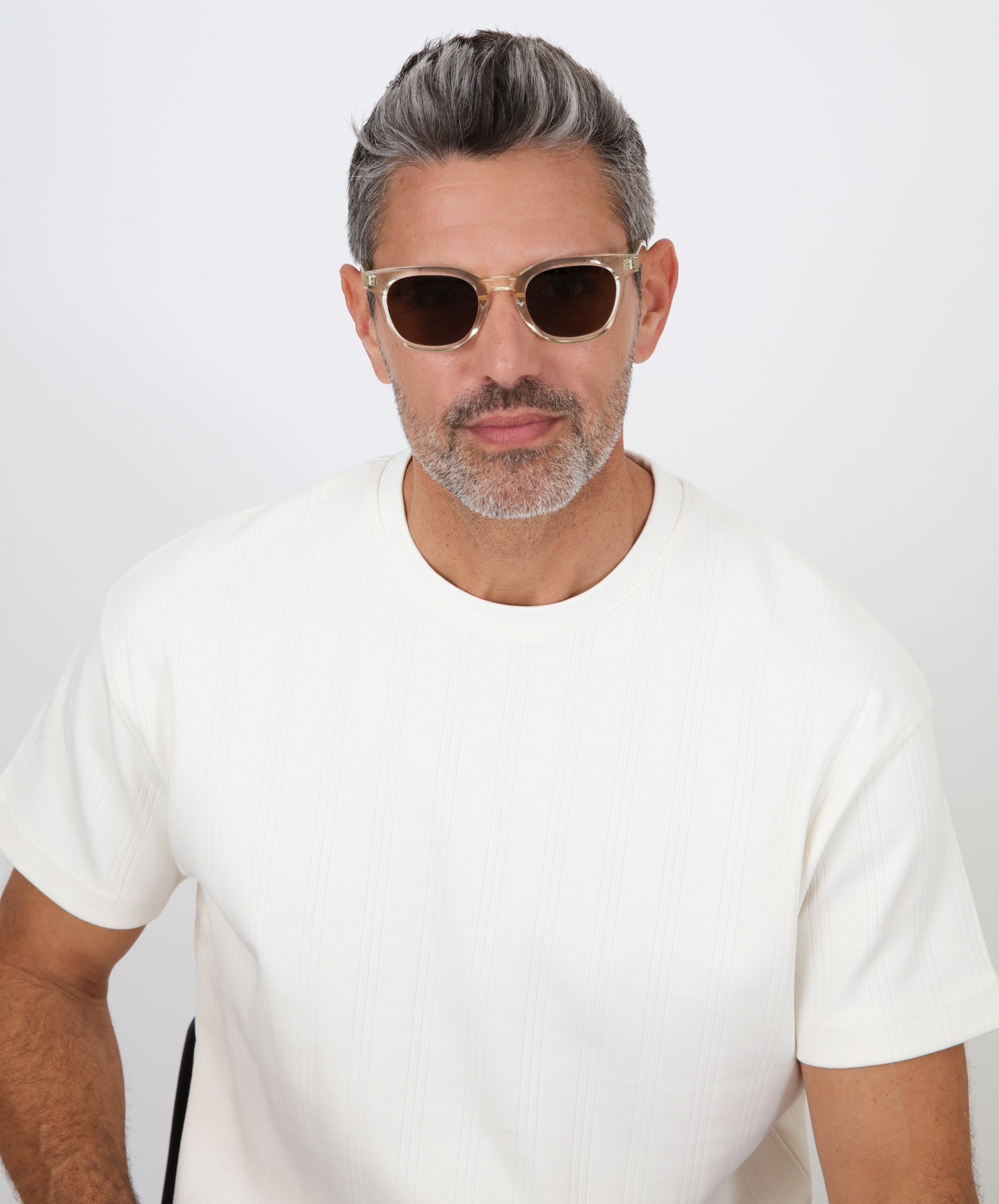 Model with salt and pepper hair and beard wearing Veneto Sunglasses in Champagne with Brown lenses.