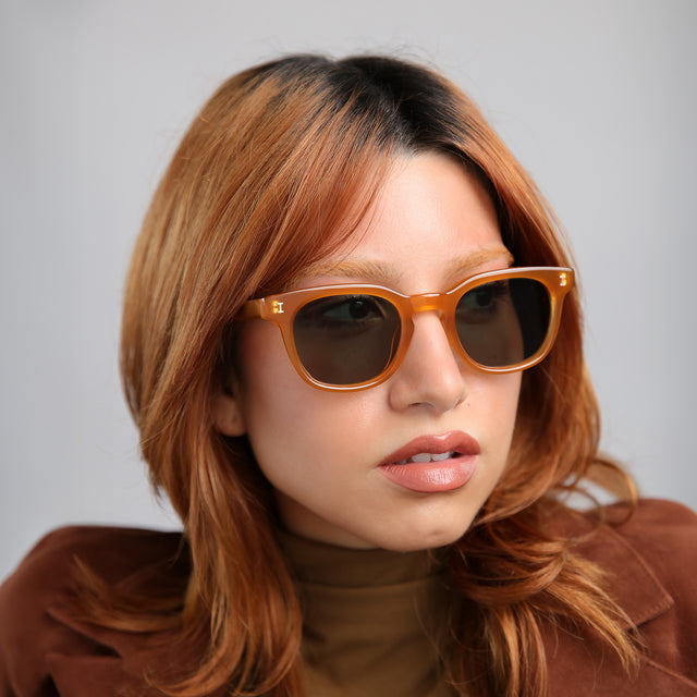 Close up of model with red hair wearing Veneto Sunglasses Honey with Olive Flat