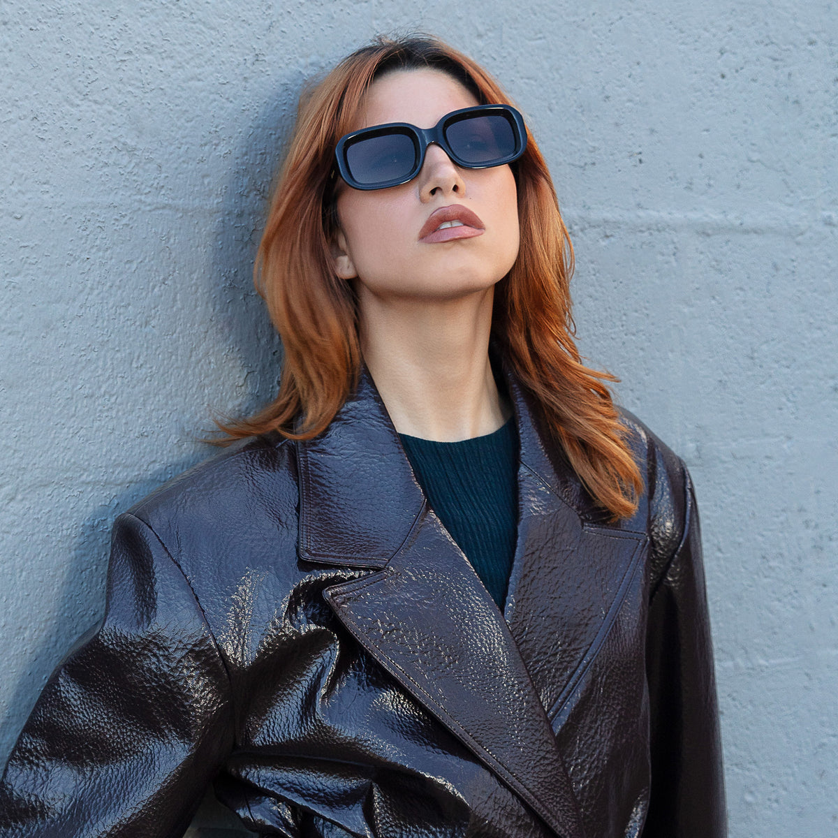 Woman wearing Vinyl Sunglasses in Black with Grey lenses, Model looking at the sky