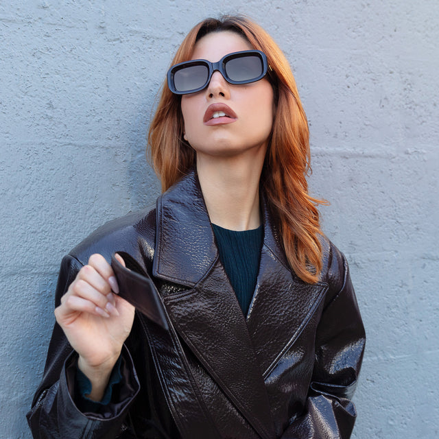 Model looking right wearing Vinyl Sunglasses Black with Grey