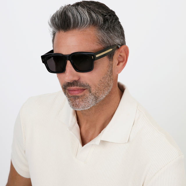 Model with salt and pepper hair and beard wearing Vito Sunglasses Black/Gold with Grey