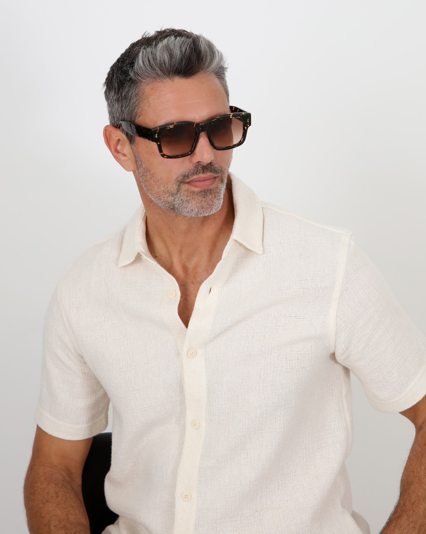 Model with salt and pepper hair and beard wearing Vito Sunglasses in Citrine with Brown Gradient lenses.