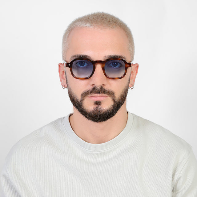 Model with platinum buzzcut wearing Washington Sunglasses Havana with Blue Flat Gradient See Through