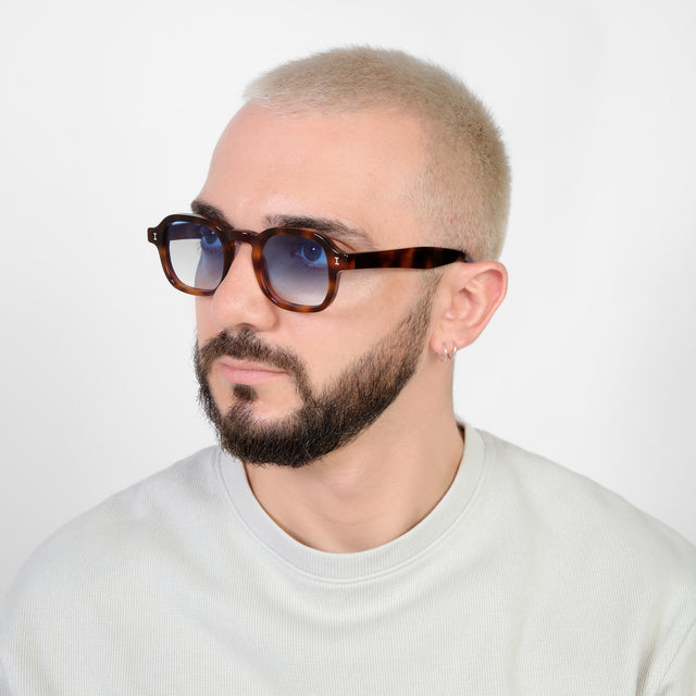 Bearded model looking right wearing Washington Sunglasses Havana with Blue Flat Gradient See Through