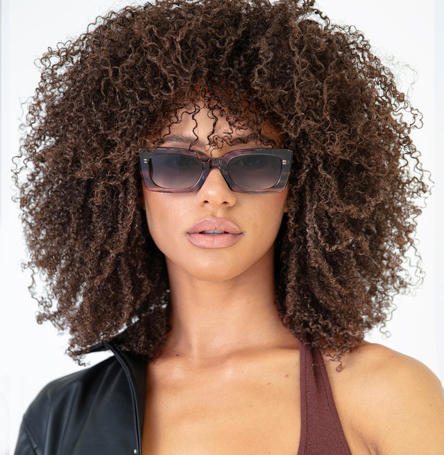 Brunette model with afro-curly hair Wilson Sunglasses Side Profile in Purple Aurora / Grey Flat Gradient