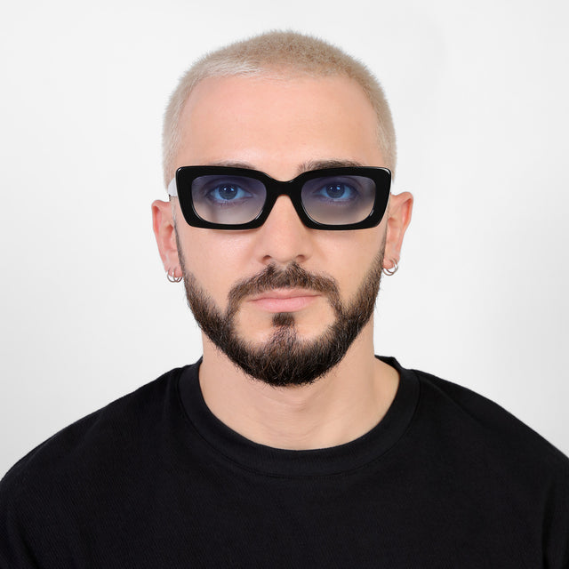 Model with a platinum buzzcut wearing Wilson Sunglasses Black with Blue Flat Gradient See Through